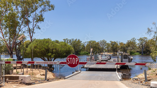 Car ferry crossing the flooded Murray River at Morgan in South Australia on a sunny day.