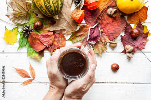 Cup of coffee and autumn leaves. photo