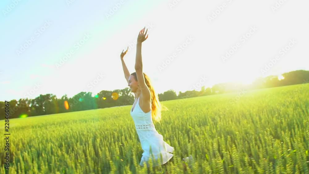 Beautiful girl running having fun on wheat field in sunset. Freedom, health, happiness concept. Happy young woman in field. Beauty girl with long hair enjoying nature outdoors. Slow mo, Sun lens flare Beautiful girl running having fun on wheat field in sunset. Freedom, health, happiness concept. Happy young woman in field. Beauty girl with long hair enjoying nature outdoors. Slow mo, Sun lens flare