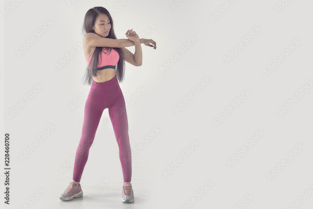 Be motivated! Beautiful sexy fitness woman posing full lengthd. middle eastern female sports clothing relaxing after workout grey background. Muscular female body. Image with copyspace Be motivated! Beautiful sexy fitness woman posing full lengthd. middle eastern female sports clothing relaxing after workout grey background. Muscular female body. Image with copyspace