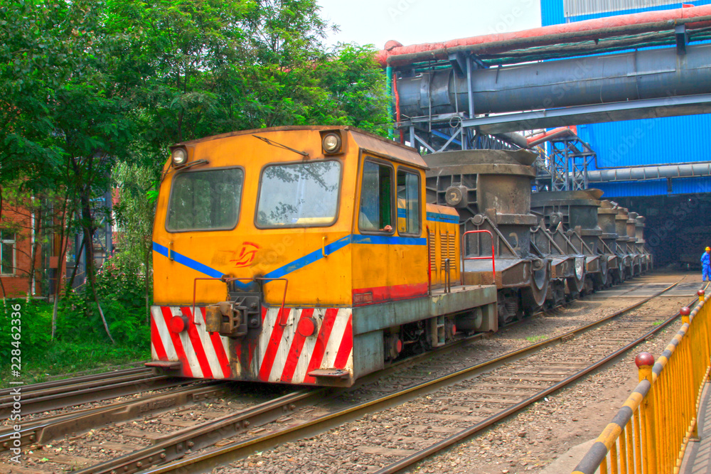 Fototapeta premium Transport molten iron crucible vehicle in the steel mills, closeup of photo