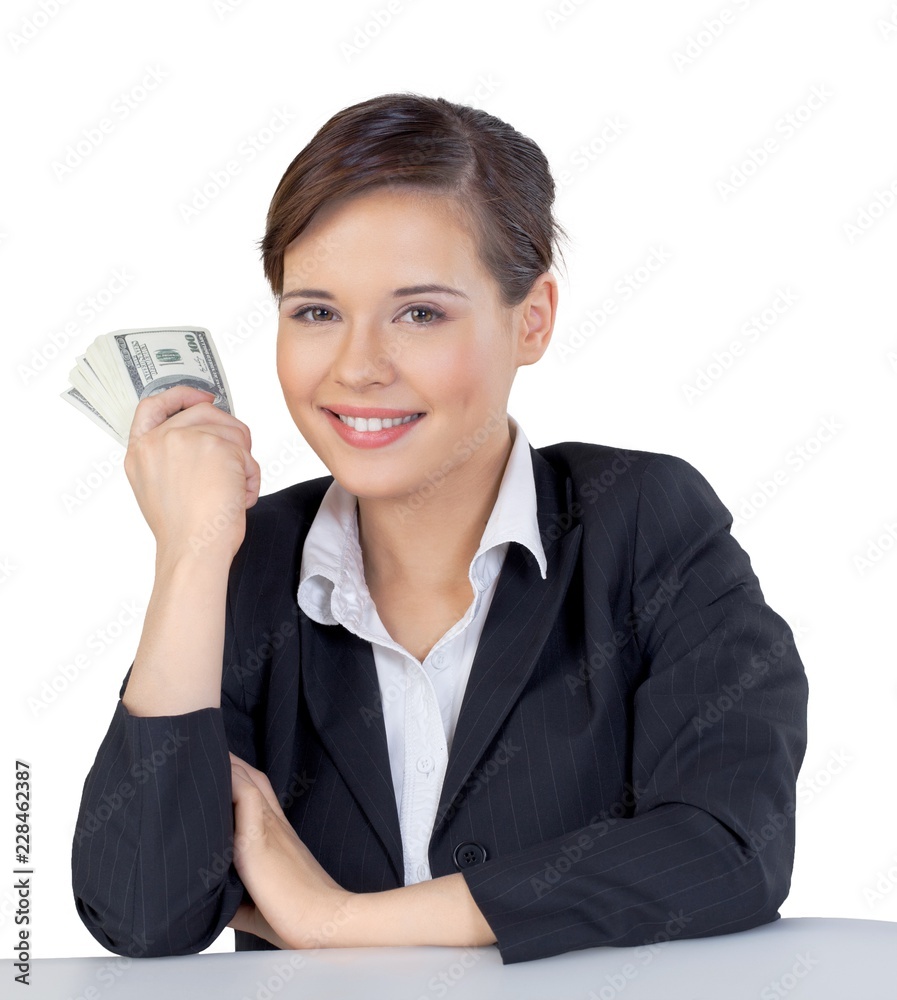 Smiling Businesswoman Sitting at the Desk and Holding Money Smiling Businesswoman Sitting at the Desk and Holding Money
