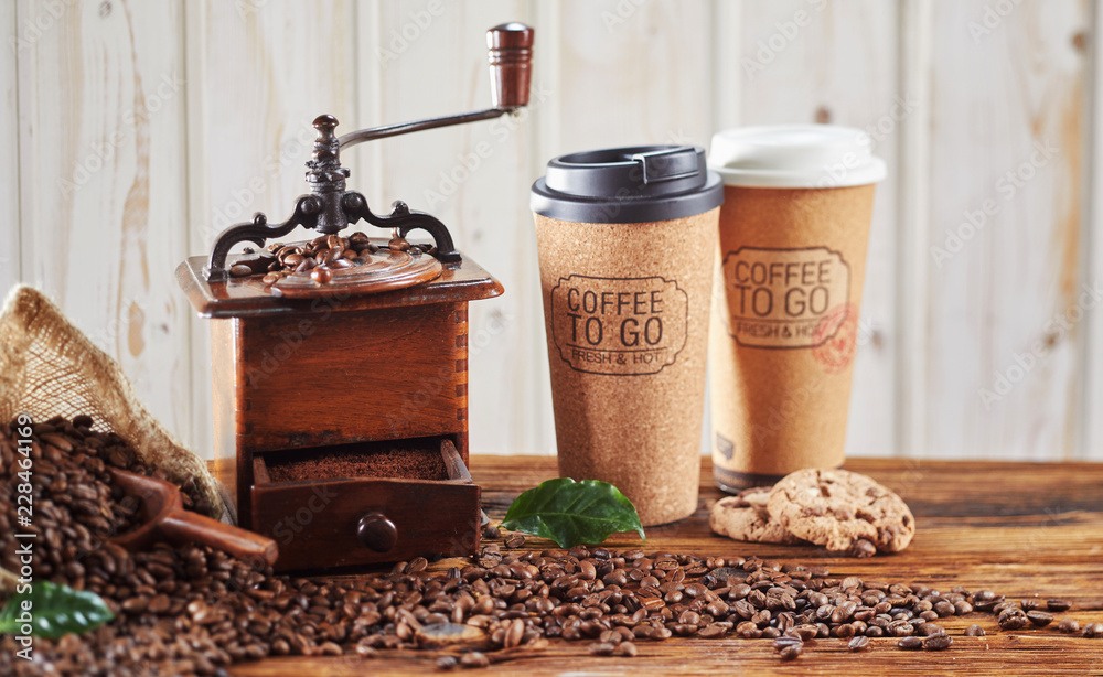 Vintage wooden coffee grinder with takeaway cups
