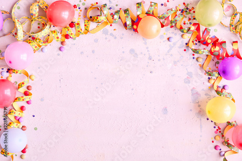 Carnival balloon border on a pink background