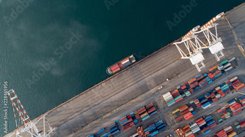 Aerial view or top view of cargo ship, cargo container in warehouse harbor ,shipyard import export logistics concept for background