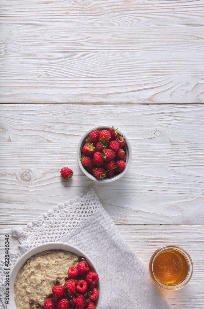 Oatmeal in a plate. Napkin. Nuts Berries. Honey Oatmeal in a plate. Napkin. Nuts Berries. Honey