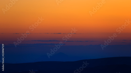 The sky at sunset over the hills in the foothills of the North Caucasus in Russia. © olgapkurguzova