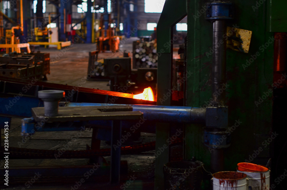 Fototapeta premium High precision hot forging product, automotive part production by hot forging process, automatice line hot forging. Iron melting recycling work. Heavy industry metallurgical plant sparks stove metall