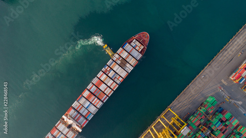 Aerial view or top view of cargo ship, cargo container in warehouse harbor ,shipyard import export logistics concept for background