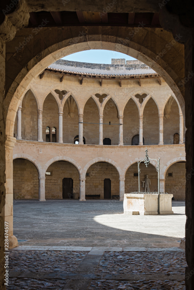 Bellver castle - inner court with well. Medieval fortress in Palma de Mallorca, Balearic Islands, Spain