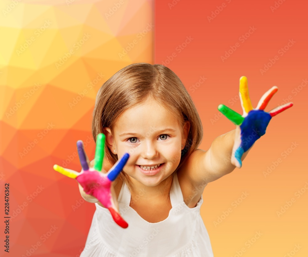 Cute little girl with colorful painted hands on light background Cute little girl with colorful painted hands on light background