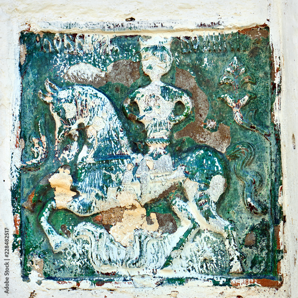 Ancient ceramic tile with a horse rider image in the wall of the Joseph-Volotsky monastery in Russia