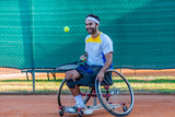 disabled tennis player dribbles with the racket