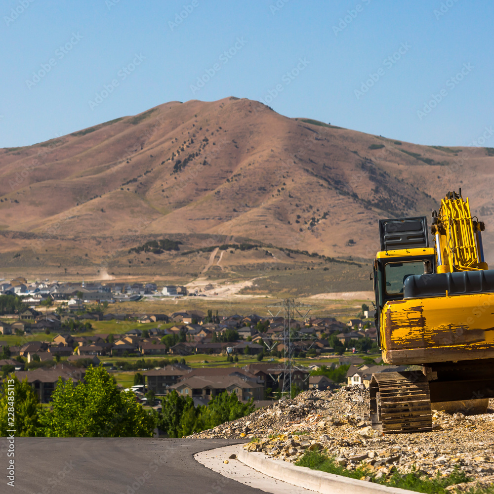 Yellow Excavator on a construction site in Utah Yellow Excavator on a construction site in Utah