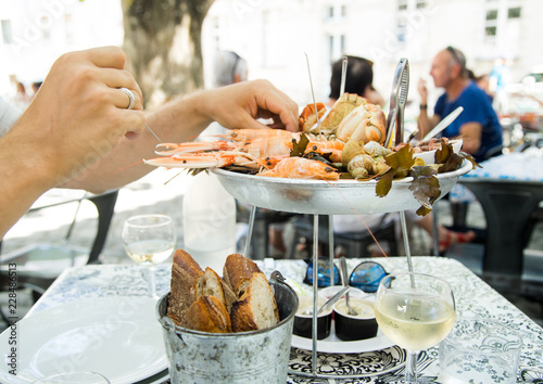 Plate with fresh assorted seafood in french summer restaurant