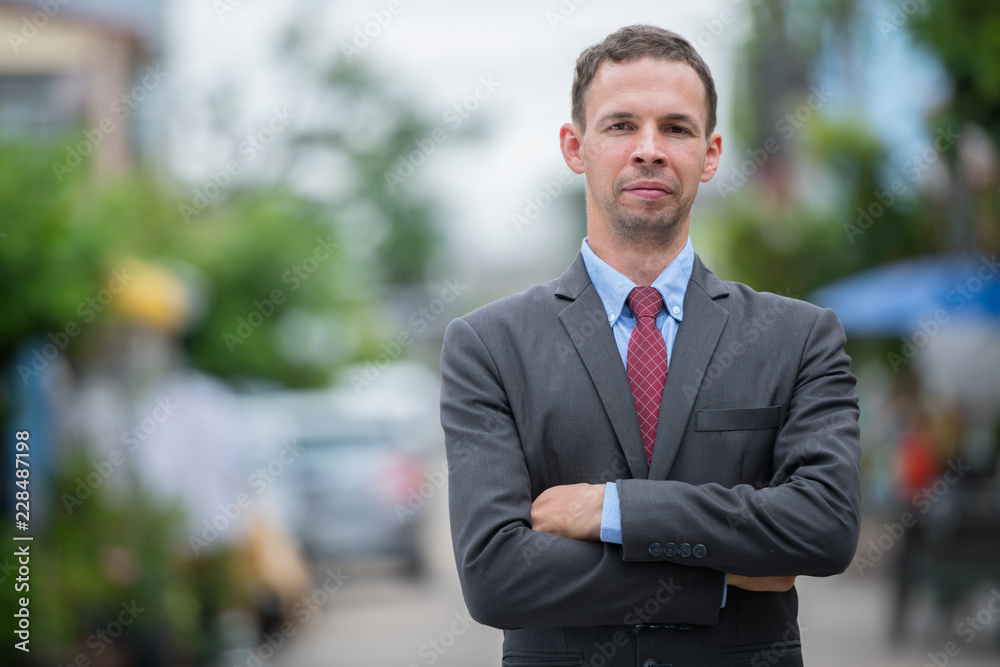 Businessman wearing suit in the streets outdoors