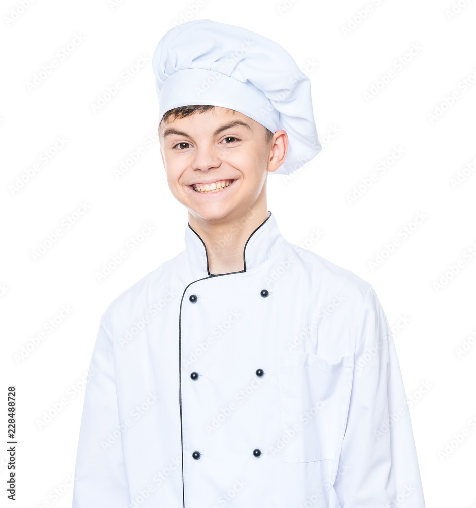 Cheerful handsome teen boy wearing chef uniform. Portrait of a happy cute male child cook, isolated on white background. Food and cooking concept. Cheerful handsome teen boy wearing chef uniform. Portrait of a happy cute male child cook, isolated on white background. Food and cooking concept.