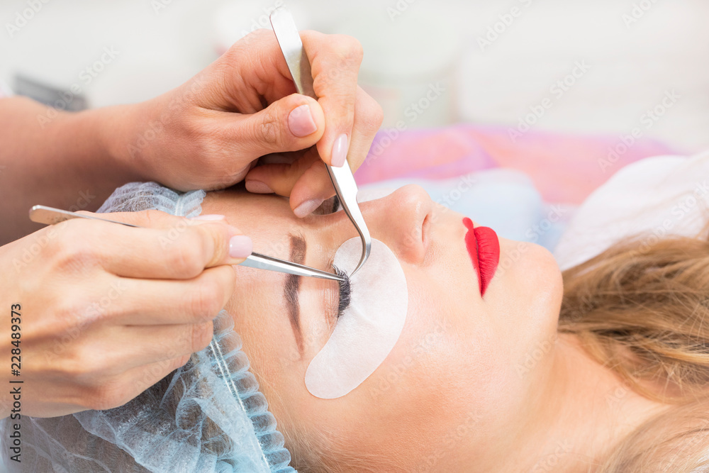 Woman on the procedure for eyelash extensions, eyelashes lamination Woman on the procedure for eyelash extensions, eyelashes lamination
