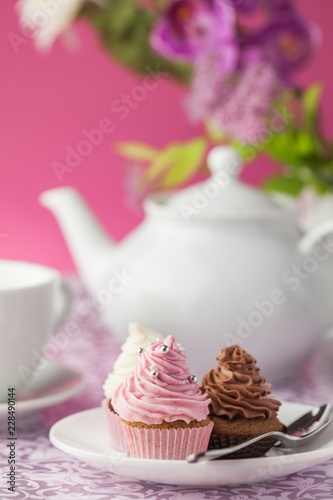 Cupcakes with Teapot and Teacup on Background © BillionPhotos.com
