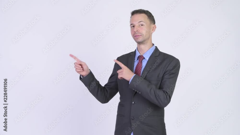 Studio shot of happy businessman showing something Studio shot of happy businessman showing something