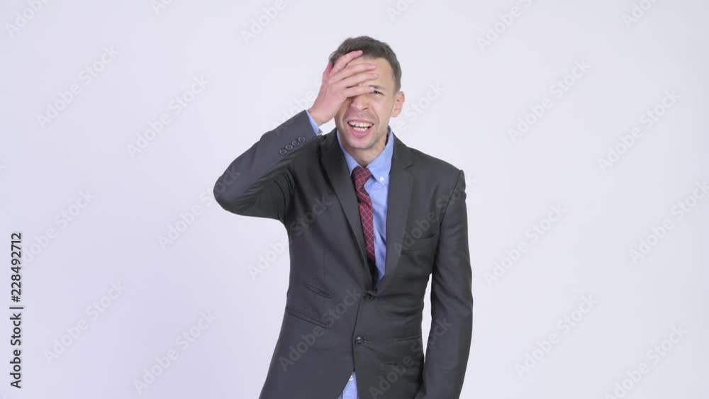 Studio shot of stressed businessman getting bad news Studio shot of stressed businessman getting bad news