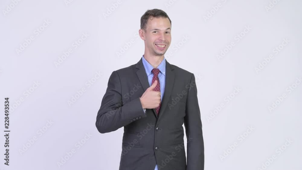 Studio shot of happy businessman giving thumbs up Studio shot of happy businessman giving thumbs up