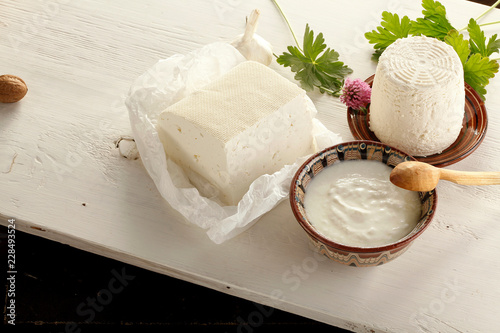 Diversity of Dairy products, cheese, yogurt, cottage cheese in traditional Bulgarian dishes on wooden table
