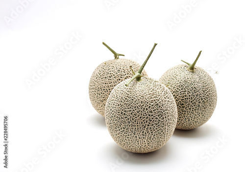 Three cantaloupe melon on white