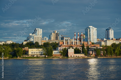 Samara, Russia - August 7, 2018: View of the industrial center of Samara from a pleasure boat on the Volga River on a sunny day.