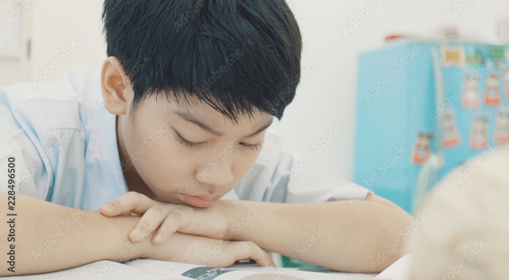 Asian child in student uniform to do homework at home. Asian child in student uniform to do homework at home.