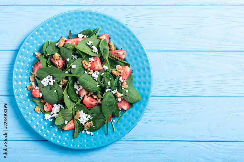 Naklejka premium Strawberry salad with spinach , cheese and walnut