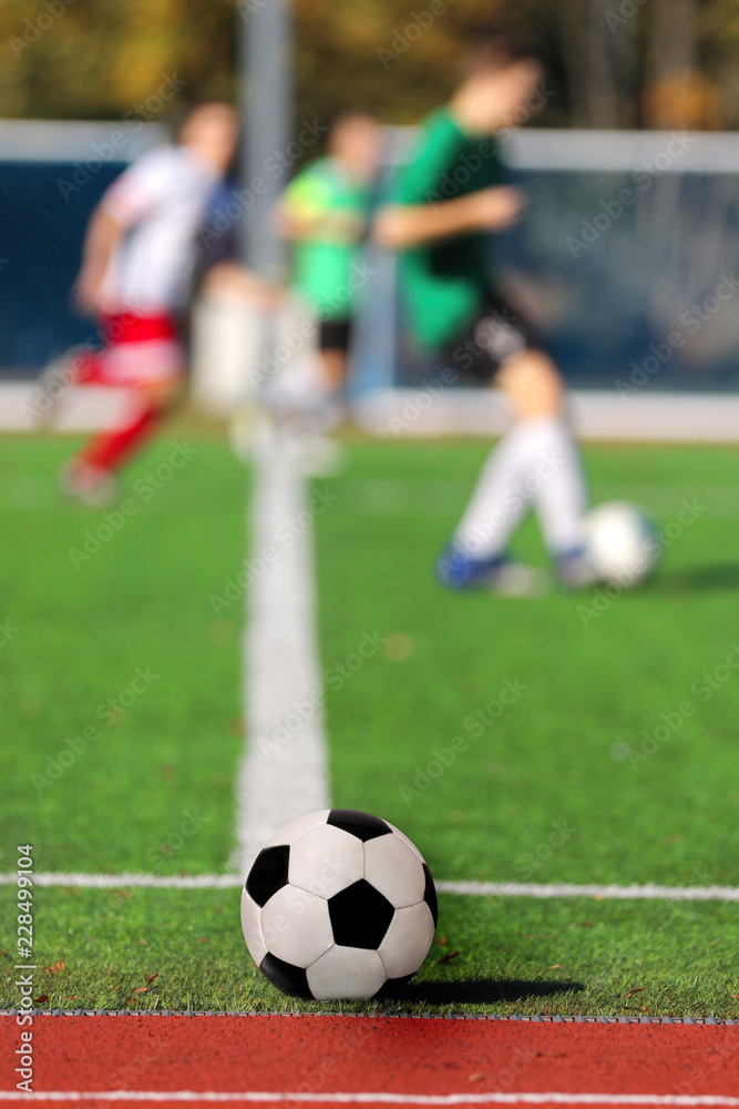 Boys playing a football match and empty space for text