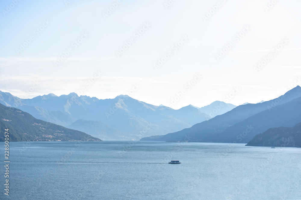 Lonely ferry cruising on Lake Como Lonely ferry cruising on Lake Como