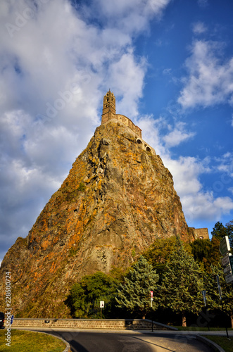 Ancient Chapel Saint Michel de Aiguilhe standing at a very steep volcanic needle (Le Puy en Velay, France) photo