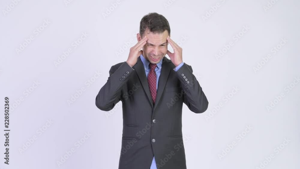 Studio shot of stressed businessman having headache Studio shot of stressed businessman having headache