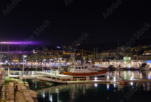 Boats parked in Porto Antico at night