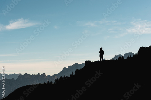 Silhouette of a woman hiking on the Dolomites Italy
