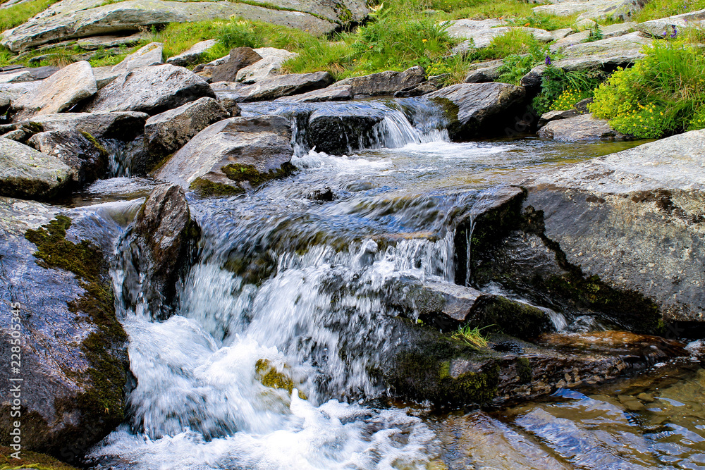 A small waterfall in the water stream. A small waterfall in the water stream.