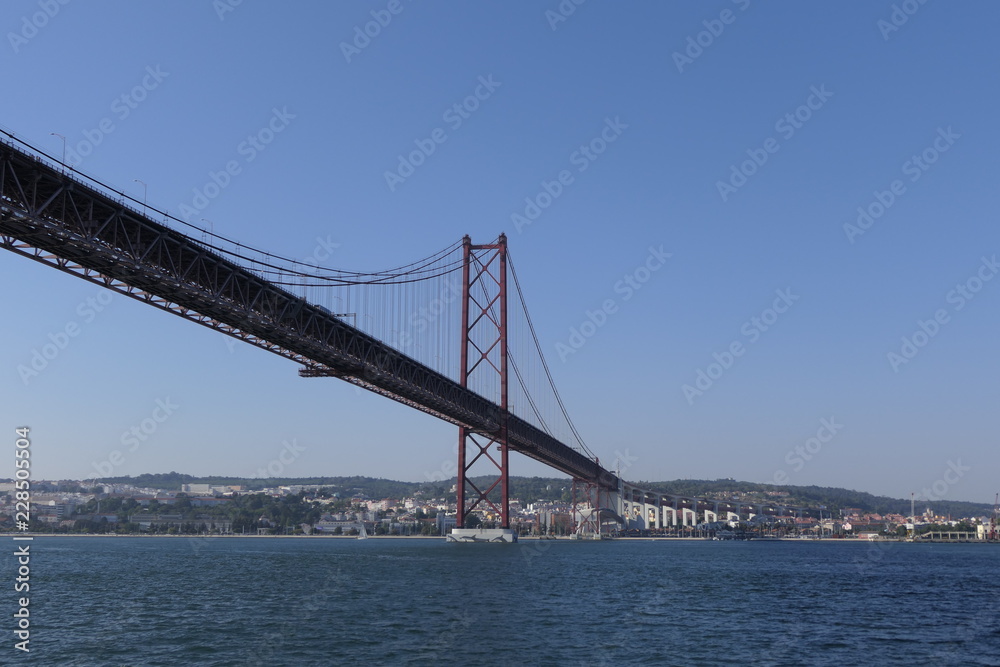 Fototapeta premium The 25 April bridge (Ponte 25 de Abril) the famous steel suspension bridge located in Lisbon, Portugal