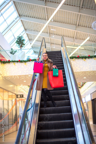 holidays shopping- Happy girl in Christmas shopping Consumerism, Christmas, shopping, lifestyle concept. © Lucky Fenix