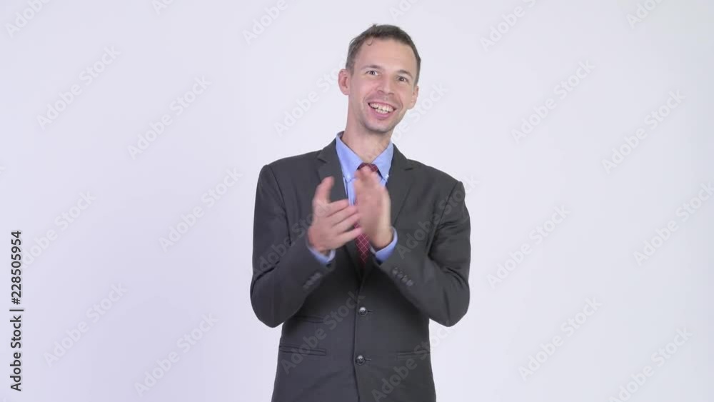 Studio shot of happy businessman clapping hands Studio shot of happy businessman clapping hands