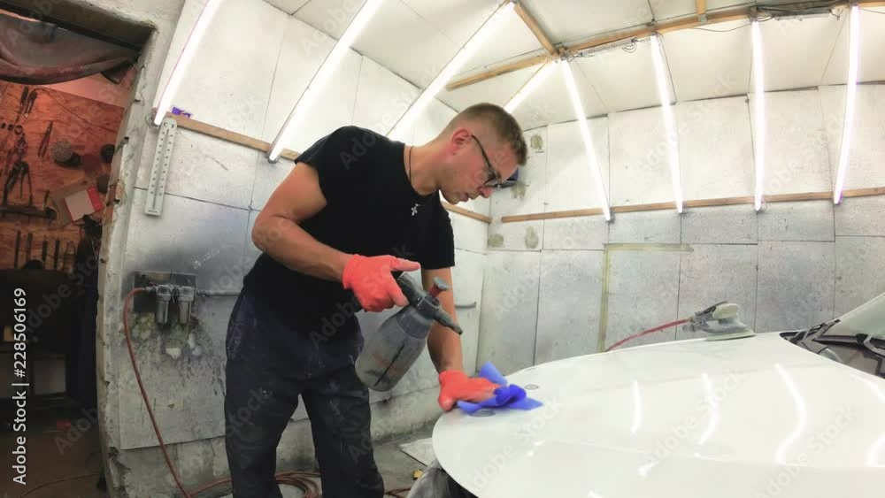 young man repairs cars in the garage. young man repairs cars in the garage.