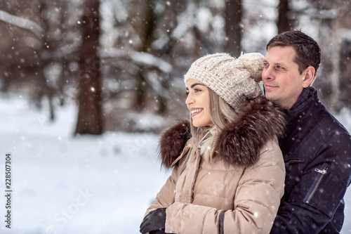 winter holidays, Christmas and people concept – Romantic couple is having fun outdoors in winter.