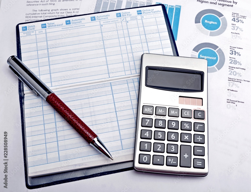 Pen, Balance Book And Calculator On Financial Reports Pen, Balance Book And Calculator On Financial Reports