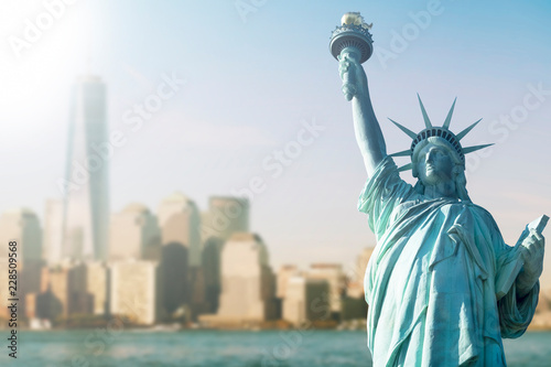 STATUE OF LIBERTY WITH BLUR BACKGROUND OF ONE WORLD TRADE CENTER AND SKYSCRAPERS IN MANHATTAN  NEW YORK  USA