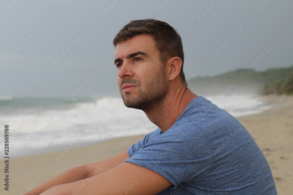 Man thinking at the beach with copy space