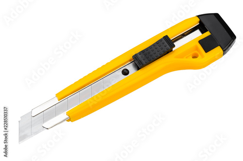 The yellow stationery knife isolated on white background photo