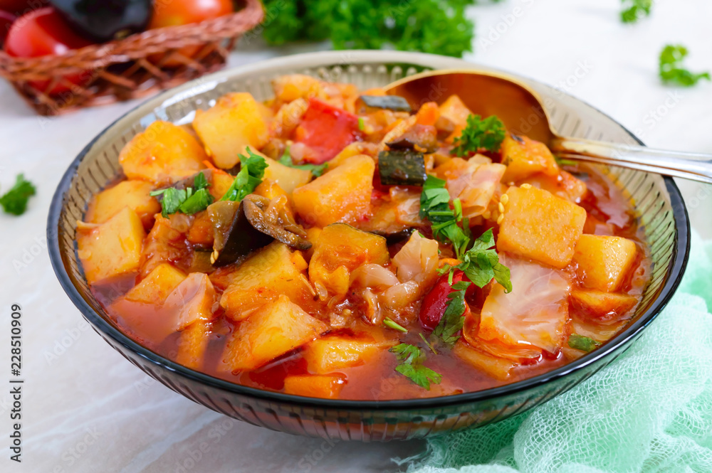 Delicious vegetable stew in a glass bowl. A popular dish of many countries of the world. Vegetarian menu Delicious vegetable stew in a glass bowl. A popular dish of many countries of the world. Vegetarian menu
