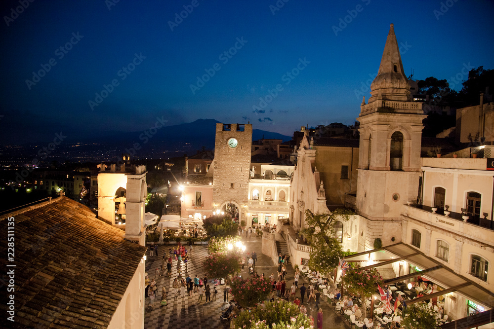 Night view of Taormina town, Sicily Italy, main square, piazza 9 aprile, panorama with mount etna 