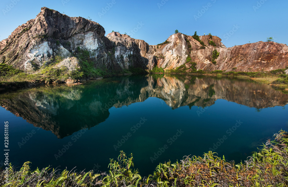 Beautiful lake and hill with reflection at an abandoned mining site 